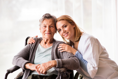 caregiver and old woman smiling