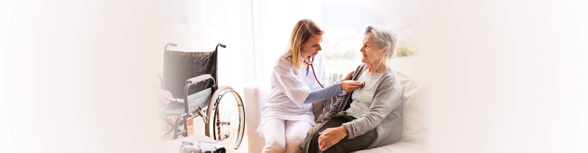 caregiver checking the health of an elderly woman